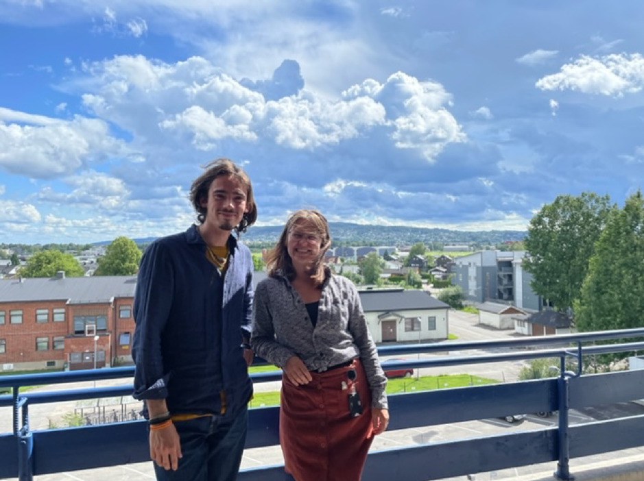 sky, two persons standing on a balcony
