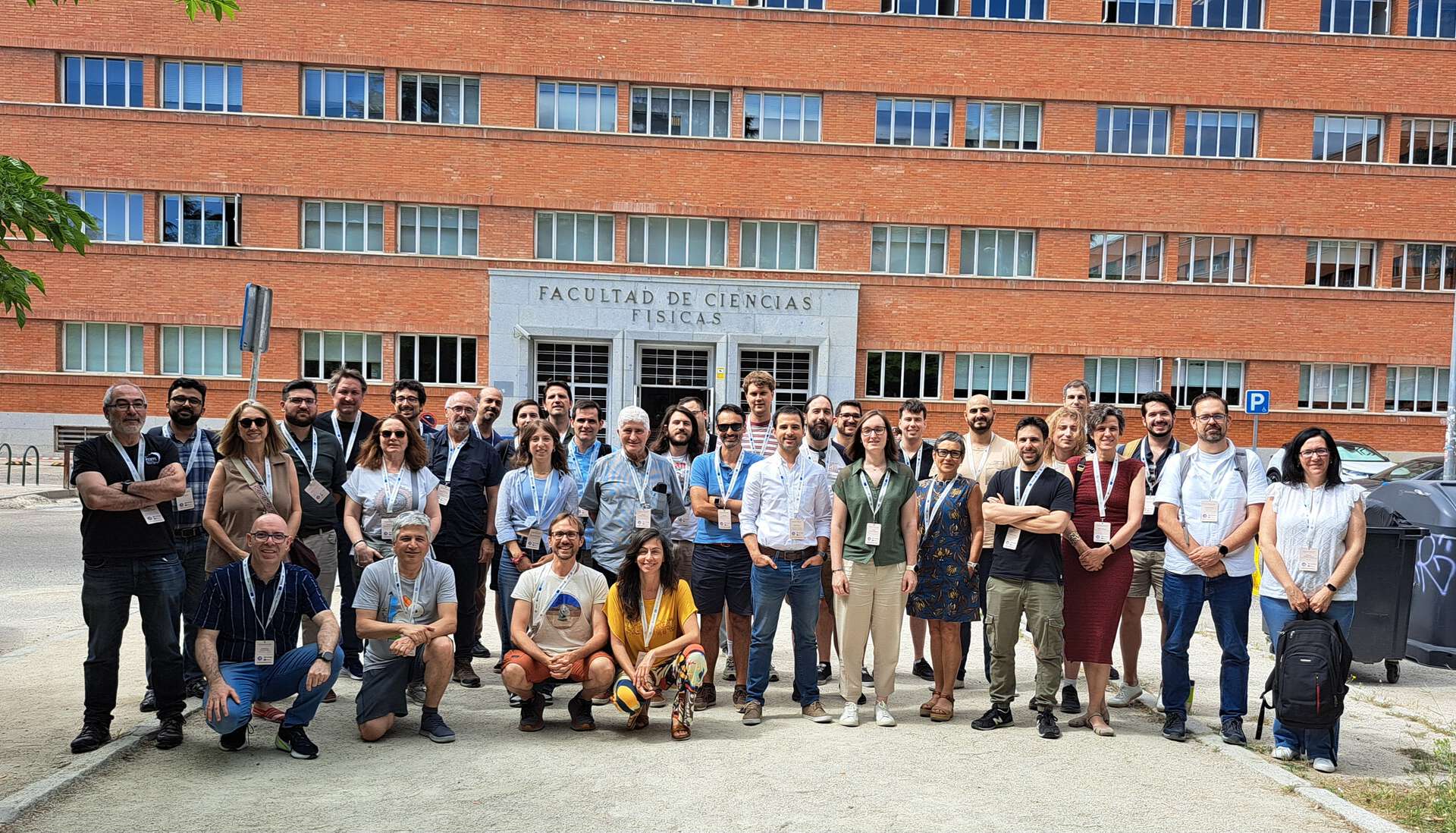 Group photo of people in front of a brick building